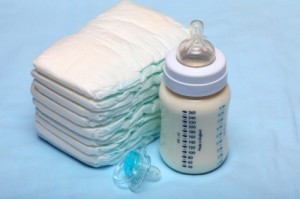 Baby bottle with milk, diapers and pacifier.