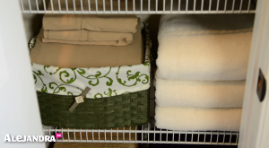 Closet Organizing Tip: Hide Fitted Sheets Inside Baskets to Keep Your Linen Closet Looking Neat & Organized